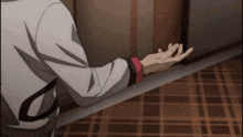 a person 's hand is reaching out towards the door