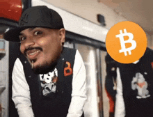 a man wearing a ny hat stands in front of a bitcoin symbol