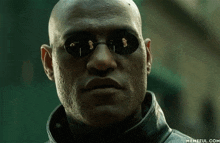 a close up of a man wearing sunglasses with memeful.com on the bottom right