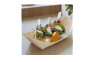 a person is holding a bowl of vegetables in their hand .