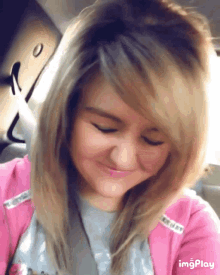 a girl in a pink jacket is taking a selfie with the words imgplay below her