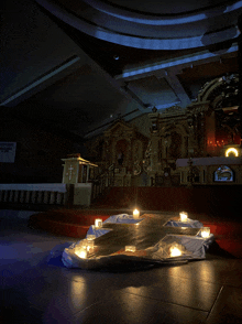 a church with a cross and candles in front of the altar