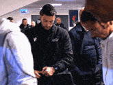 a man in a black jacket with the word liverpool on the front
