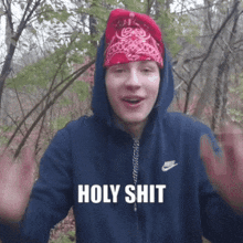 a man wearing a blue nike jacket and a red bandana is saying holy shit