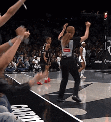a basketball game is being played on a court with the word compass on it