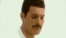 a close up of a man 's face with a mustache .