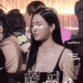 a woman wearing a black tank top with hypor written on her chest
