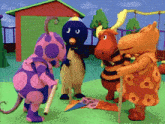 a group of stuffed animals standing next to each other in front of a house