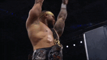 a wrestler with his arms in the air wearing a belt that says ' intercontinental ' on it