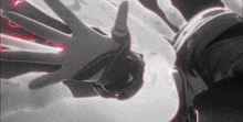a black and white photo of a person 's hand reaching out