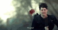 a man is holding a bow and arrow and running .