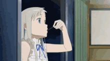 a girl in a white dress is looking out of a window and eating a snack .