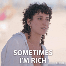 a woman with curly hair says sometimes i m rich