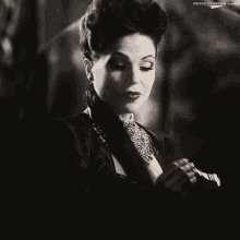 a black and white photo of a woman smoking a cigarette with the words frivolous him tumblr below her