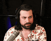 a man with long hair and a beard wearing headphones and a shirt that says ' a ' on it