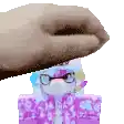 a person is putting their hand on top of a stuffed animal .