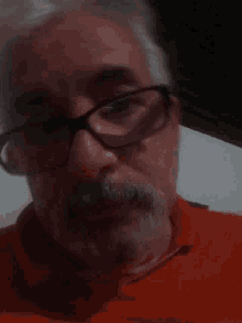 a close up of a person 's face wearing glasses