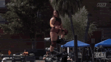 a female wrestler in a ring with a sign that says gell on it