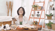 a woman sitting at a table with a stuffed animal and a phone in her hand