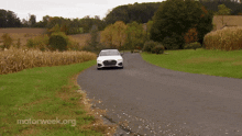 a white audi is driving down a road with motorweek.org written on the bottom