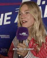 a woman speaking into a microphone that says academy