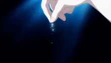 a person 's hand is reaching out towards a blue background