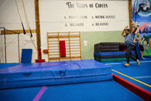 the rules of circus are written on a wall in a gym
