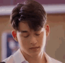 a close up of a young man with his eyes closed .