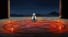 a person is sitting in a circle with a pentagram in the middle