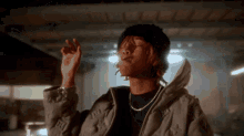 a man wearing a louis vuitton jacket is smoking