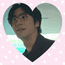 a picture of a man with glasses in a heart shaped frame