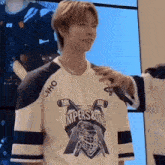 a person wearing a white and blue hockey jersey with the word ampersone on it