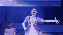 a woman in a purple dress and white gloves stands on a stage with her arms outstretched