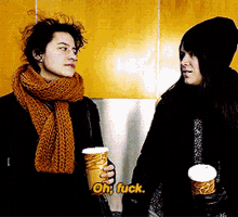 two women are holding cups of coffee and one of them says oh fuck