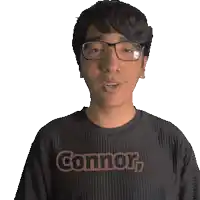 a man wearing glasses and a shirt that says connor on it