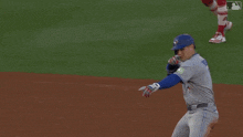 a baseball player wearing a blue jays uniform and gloves