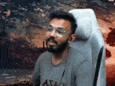 a man with a beard wearing glasses and a shirt that says astao
