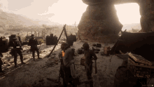 a screenshot of a video game shows a group of people standing around a campfire and a box that says treasure