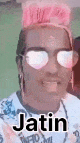 a man wearing sunglasses and a pink mohawk is called jatin
