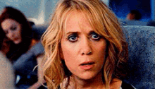 a close up of a woman 's face with a surprised expression