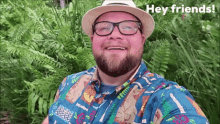 a man wearing a hat and glasses is smiling and says hey friends