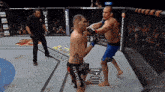 two men are fighting in a boxing ring with a metro sign in the background