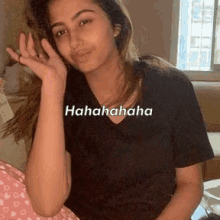 a woman in a black t-shirt is laughing while holding a little girl 's hand .
