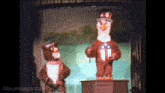 two stuffed animals are standing next to each other on a stage and mousesteps.com is visible in the corner
