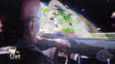 a man in a car is playing a video game with the number 1st