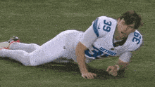 a detroit football player is laying on the grass