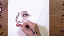 a person drawing a woman 's face with a pencil