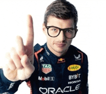 a man wearing glasses and a racing suit with oracle on it
