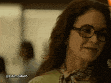 a woman wearing glasses and a scarf has the hashtag lialmeida05 below her