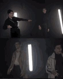a man in a trench coat is pointing at another man in a dark room